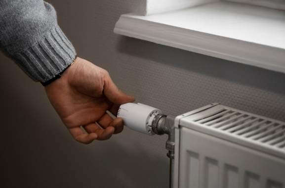 Image of someone adjusting their radiator.